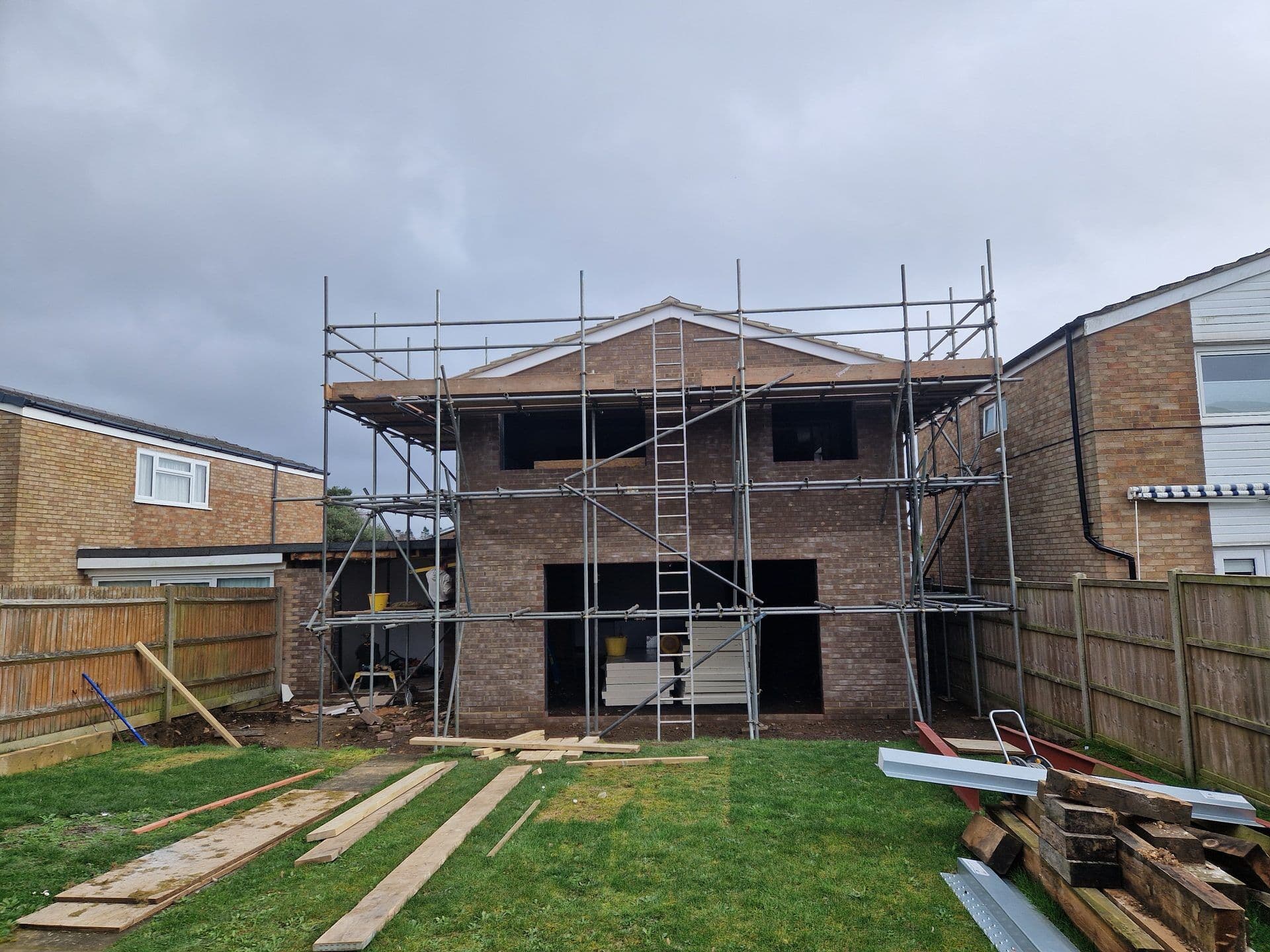 Two storey rear extension under construction with scaffolding by DNR Build