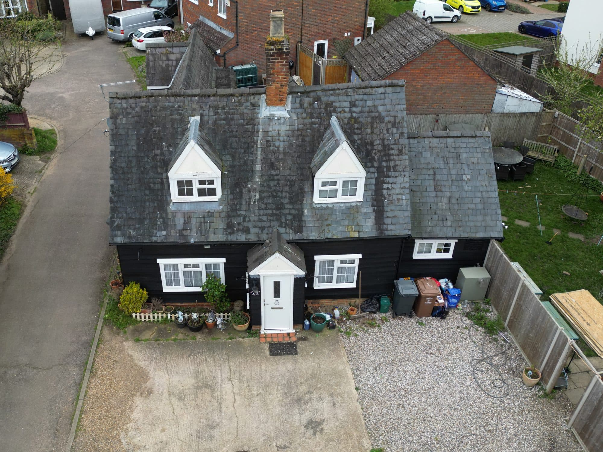 Aerial view of the cottage and its old mossy roof before the renovation