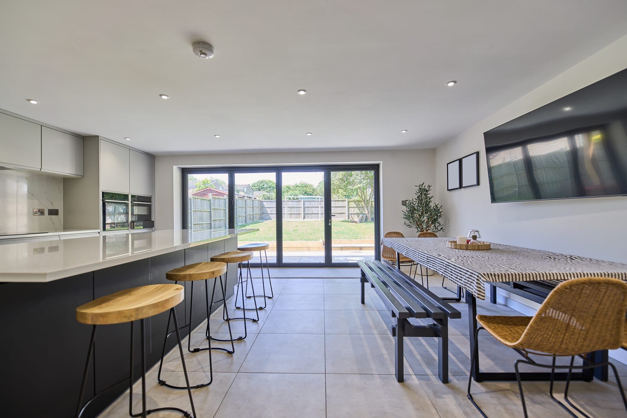 The finished dining end with bi-fold doors opening onto the garden by DNR Build