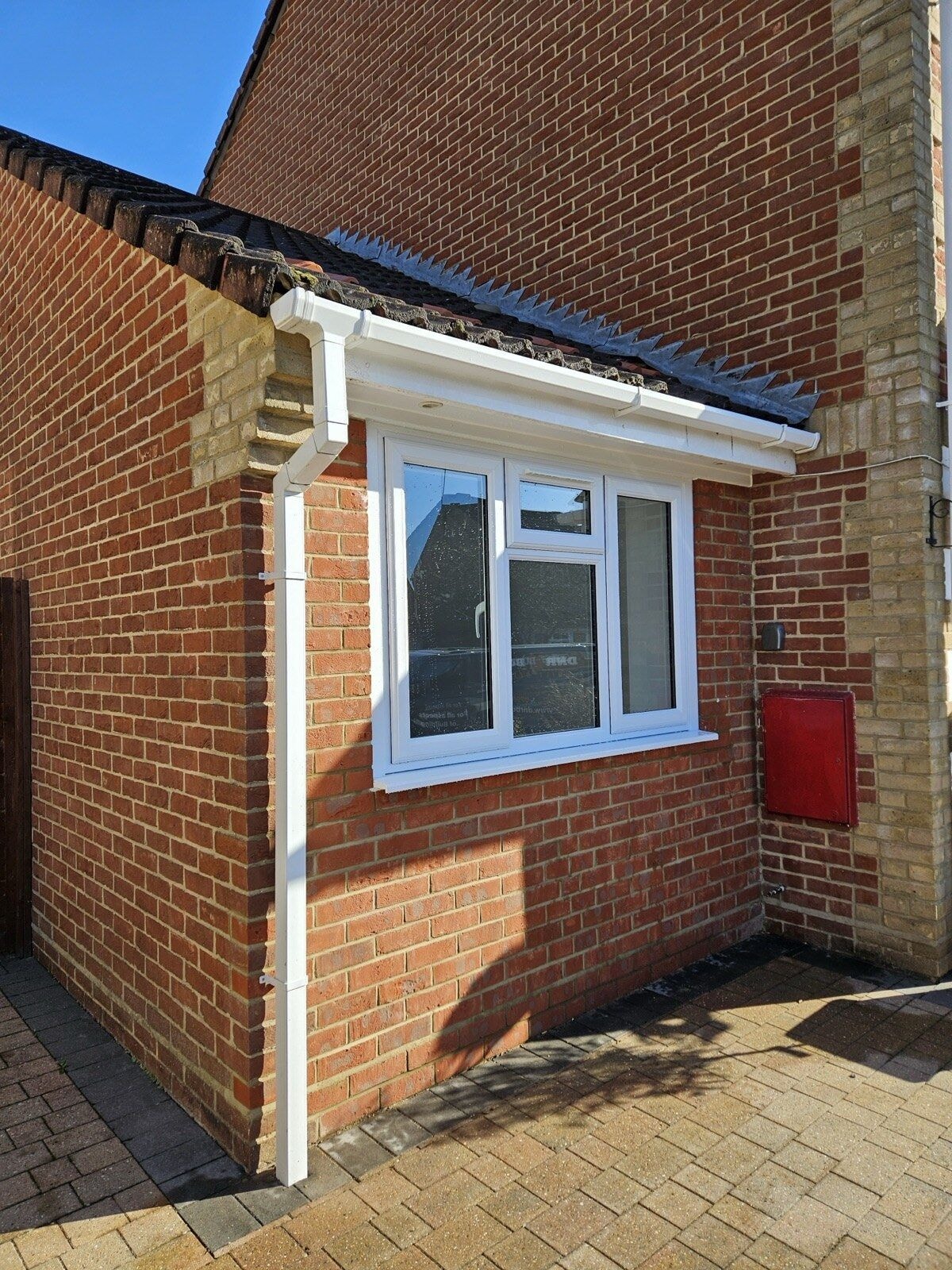New external window and brickwork on the extended garage with fresh fascia and guttering by DNR Build