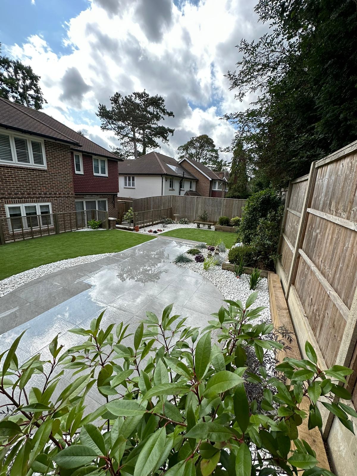 The finished garden looking back towards the house with the patio, lawn and pebble borders by DNR Build