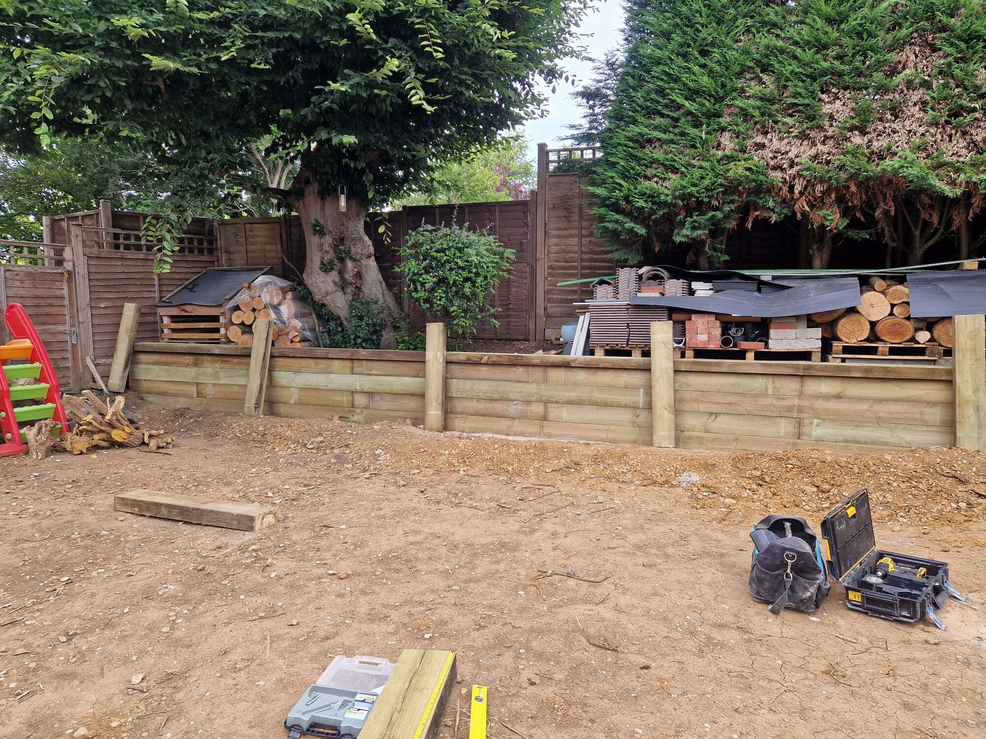 New sleeper retaining wall built across the garden with the ground prepared for the patio by DNR Build