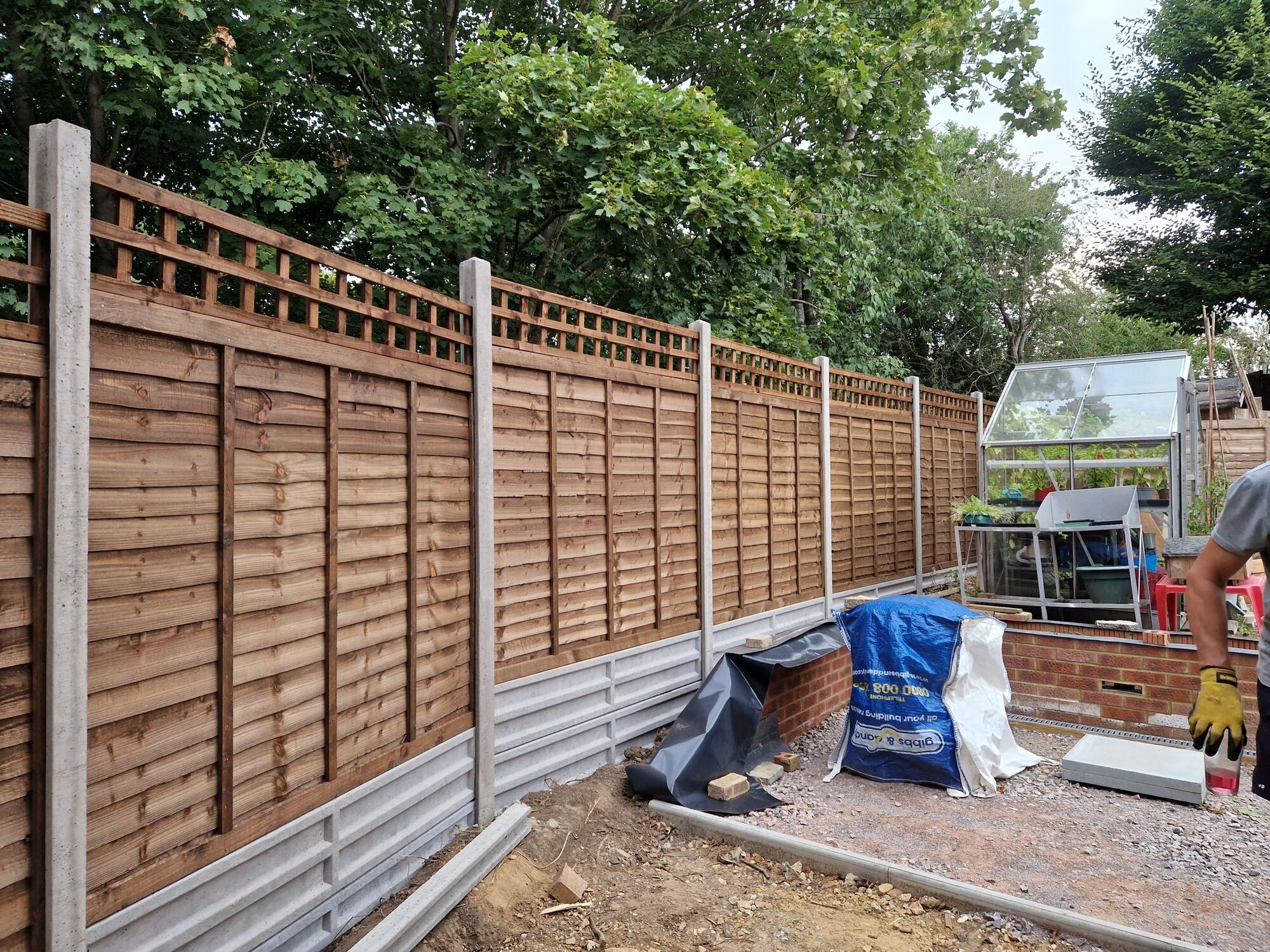 New fencing, brick wall and prepared base along the boundary during the garden revamp by DNR Build