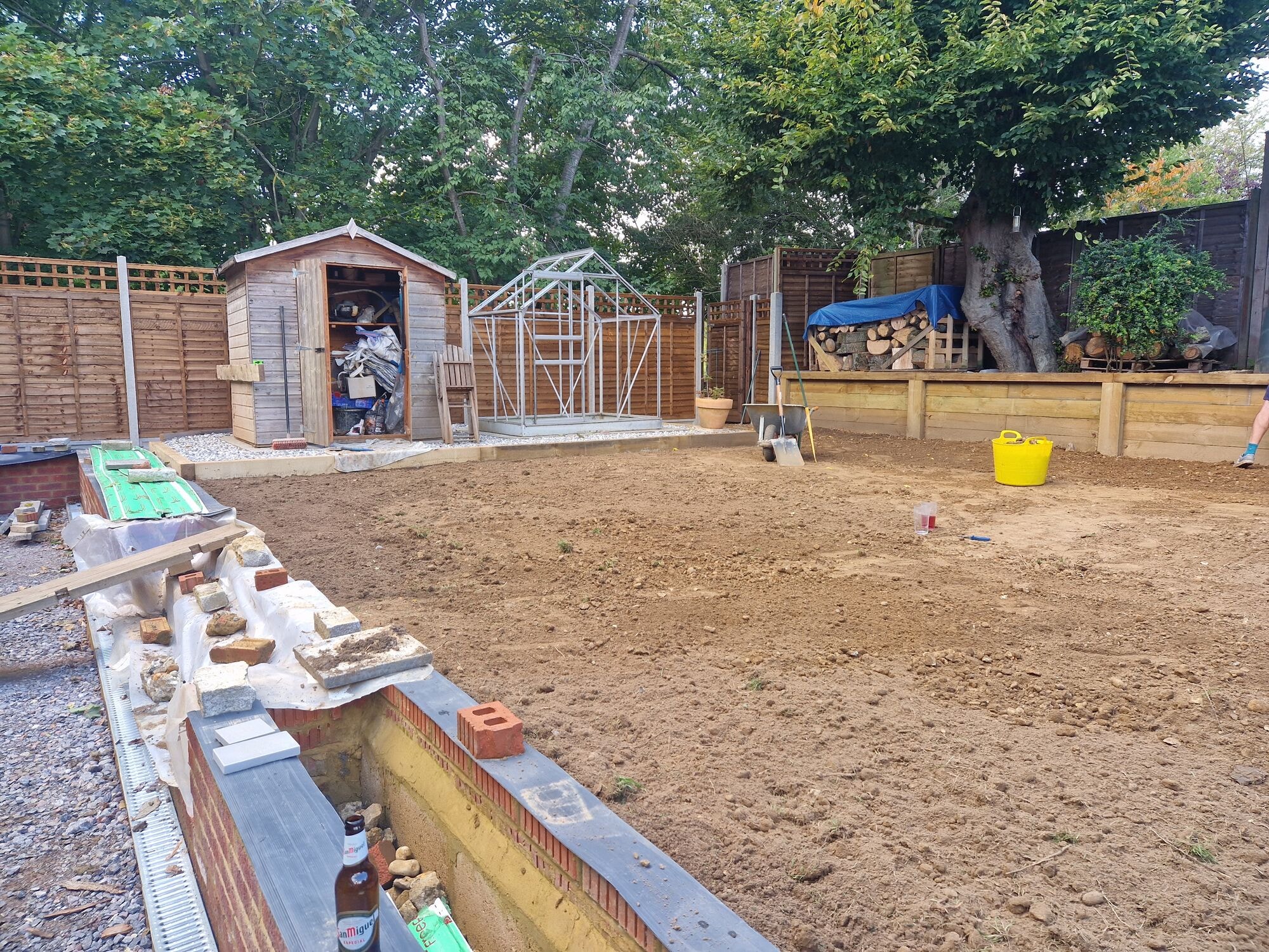 The garden raked level and prepared for turf with sleeper beds and a new brick wall by DNR Build