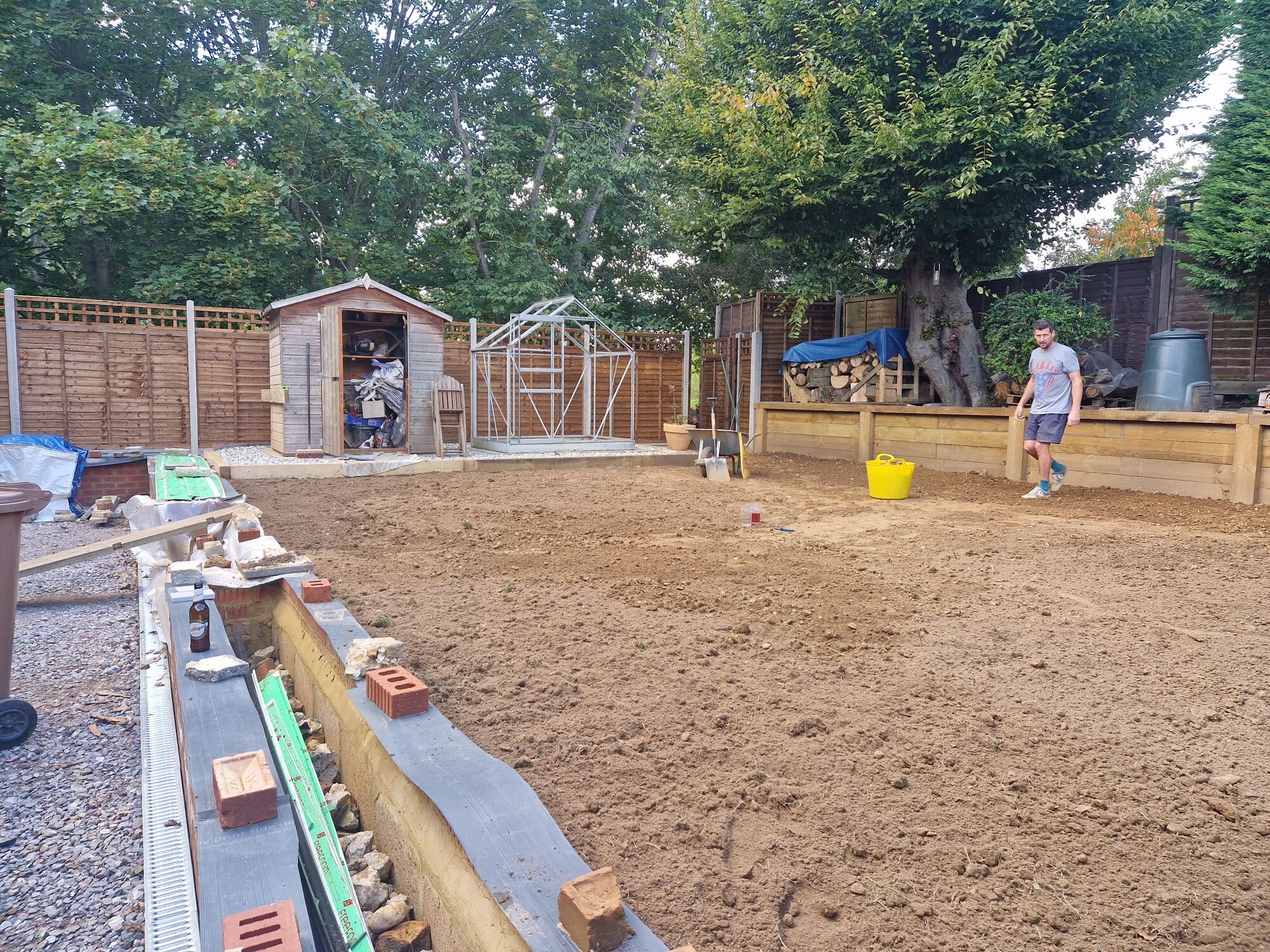 Wider view of the levelled garden ready for turf with the shed, raised beds and new brickwork by DNR Build