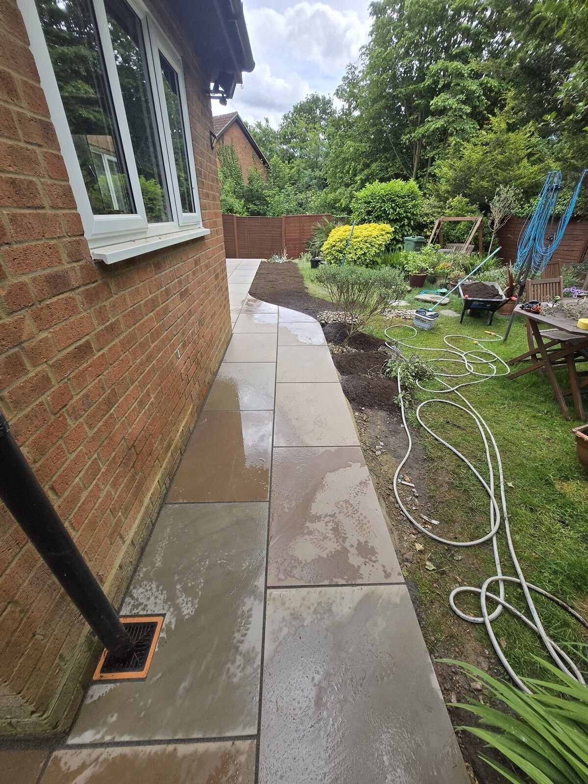 Sandstone path along the side of the house leading round to the rear garden by DNR Build