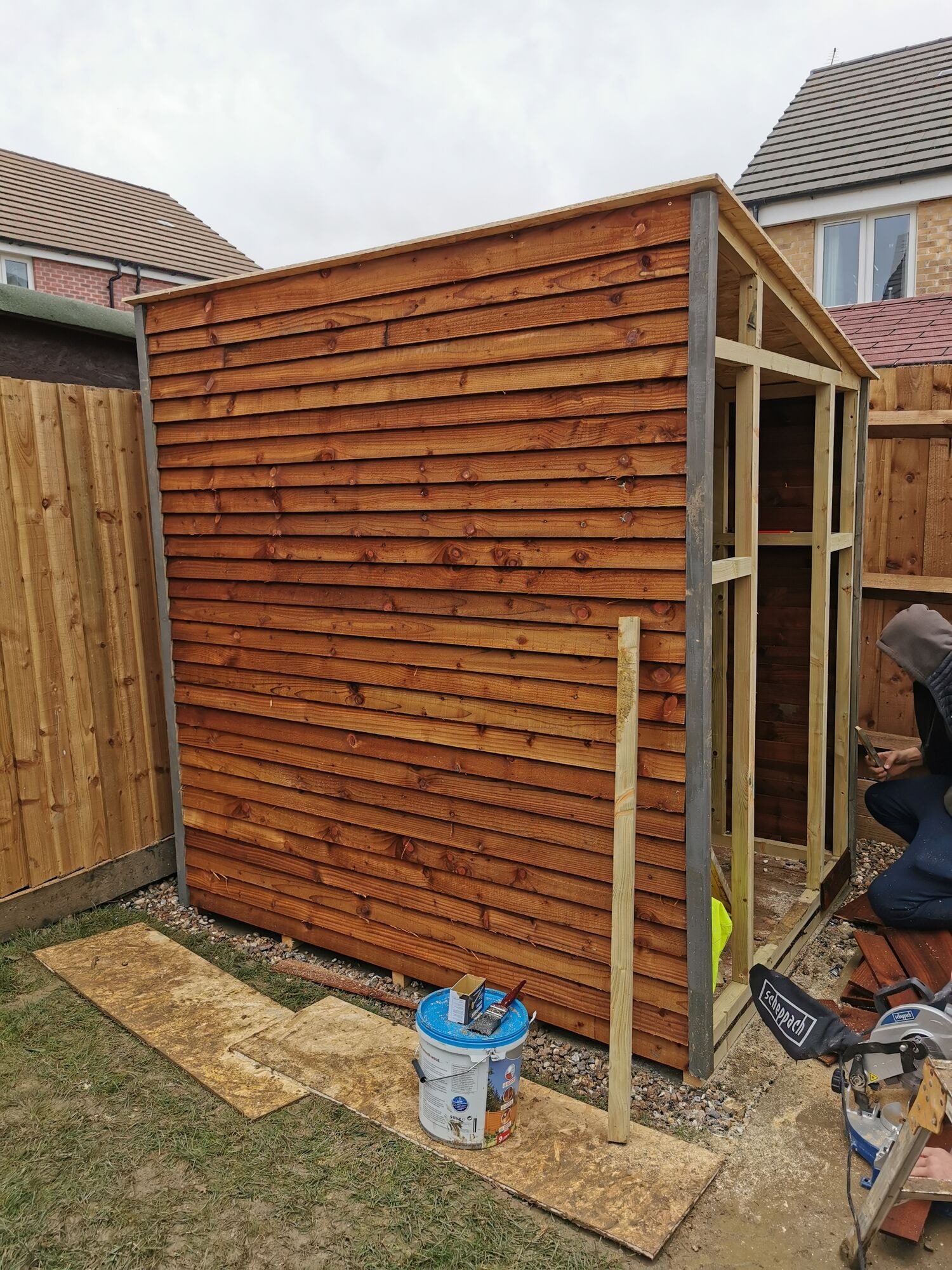 The shed being clad in feather edge timber boards over the new frame by DNR Build