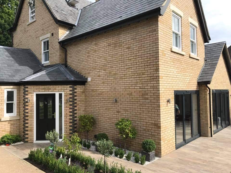 The front elevation of the home with the entrance, bi-fold doors and planted borders finished by DNR Build