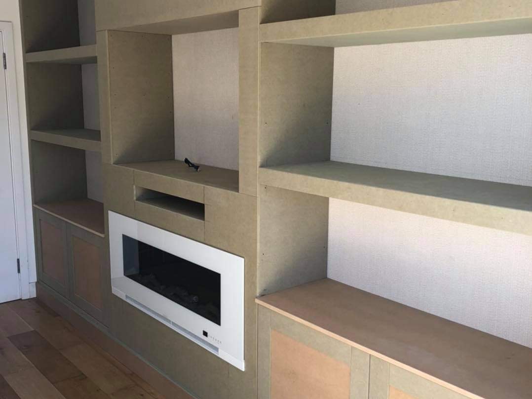 The bespoke media unit under construction showing the shelving, carcass and inset fire by DNR Build