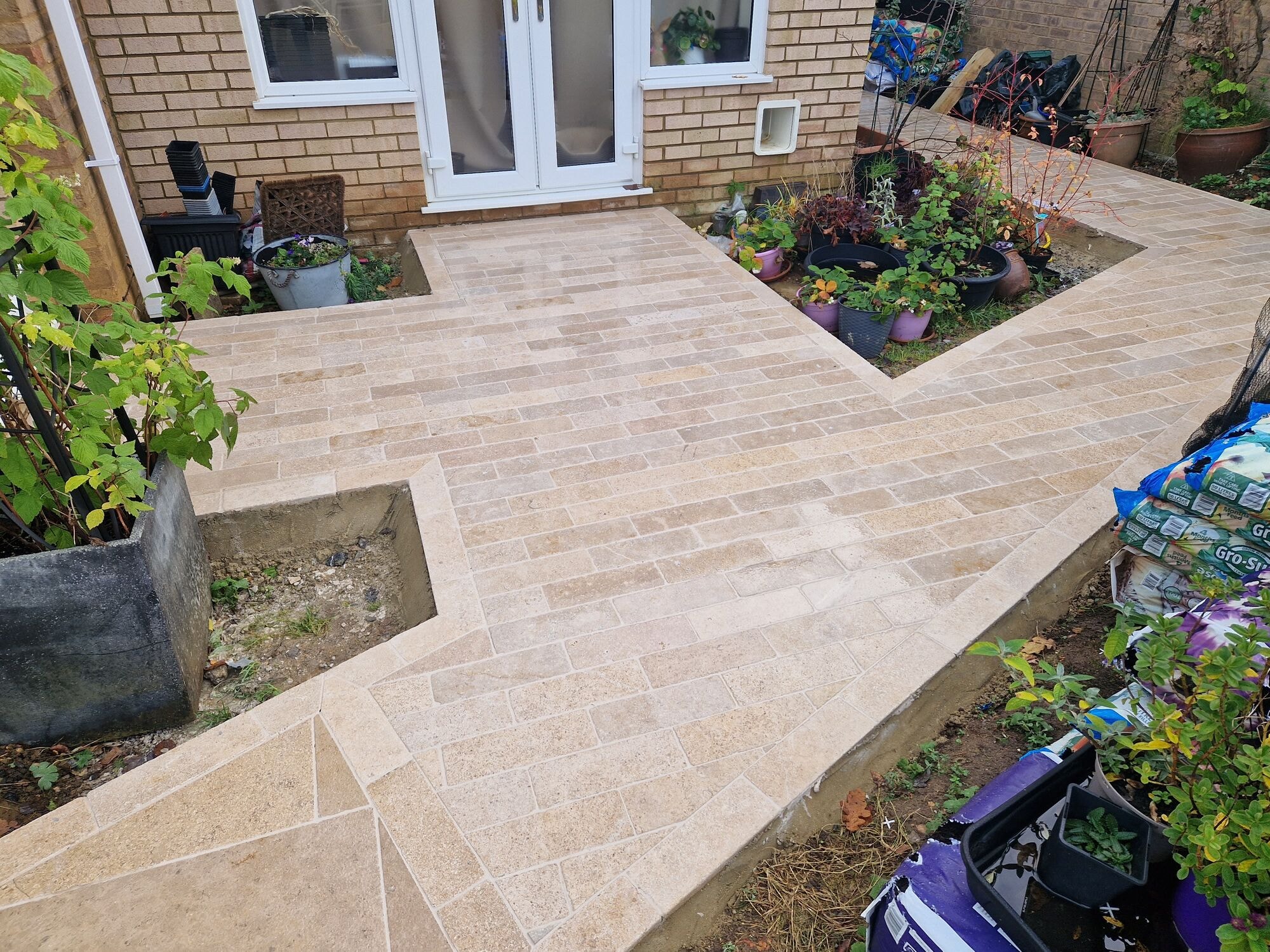 The finished patio running back to the French doors at the rear of the house by DNR Build