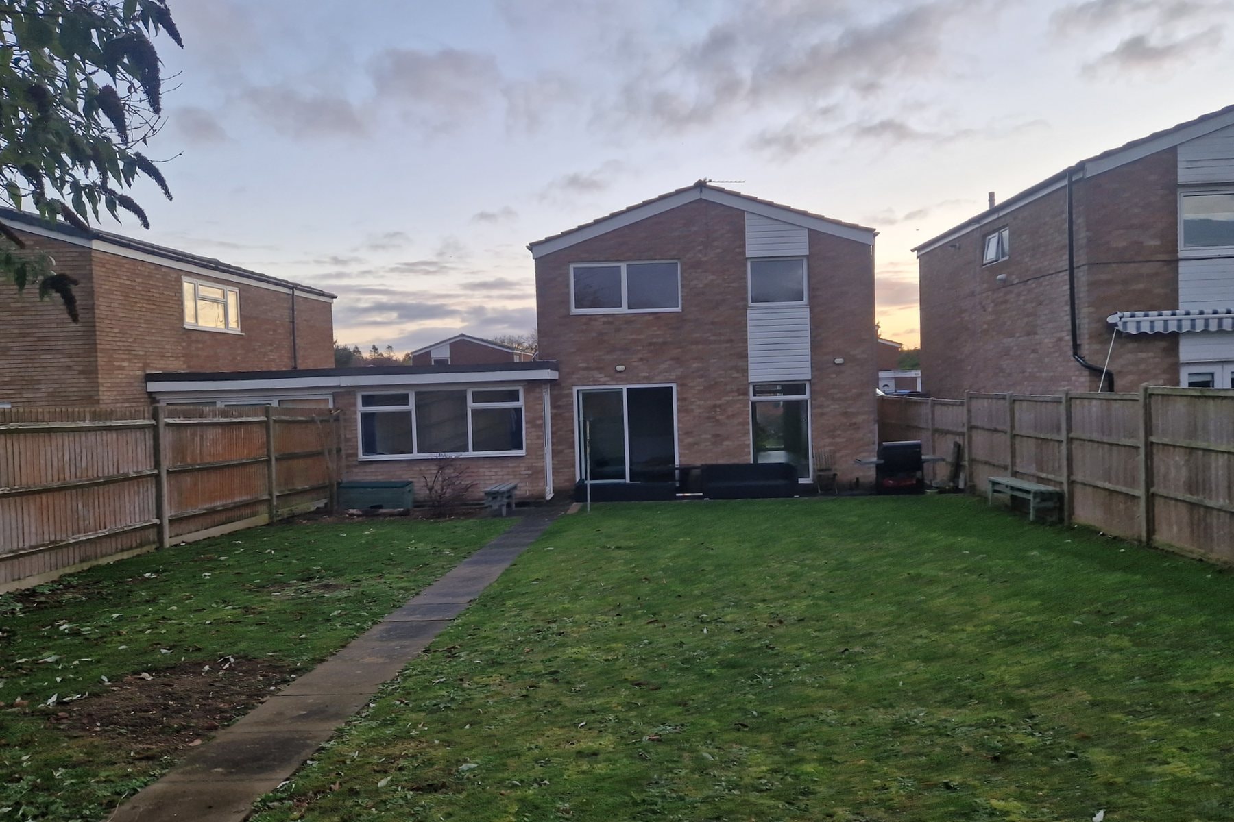 The back of the Stevenage home before the work, with an old flat roofed single storey rear and white cladding