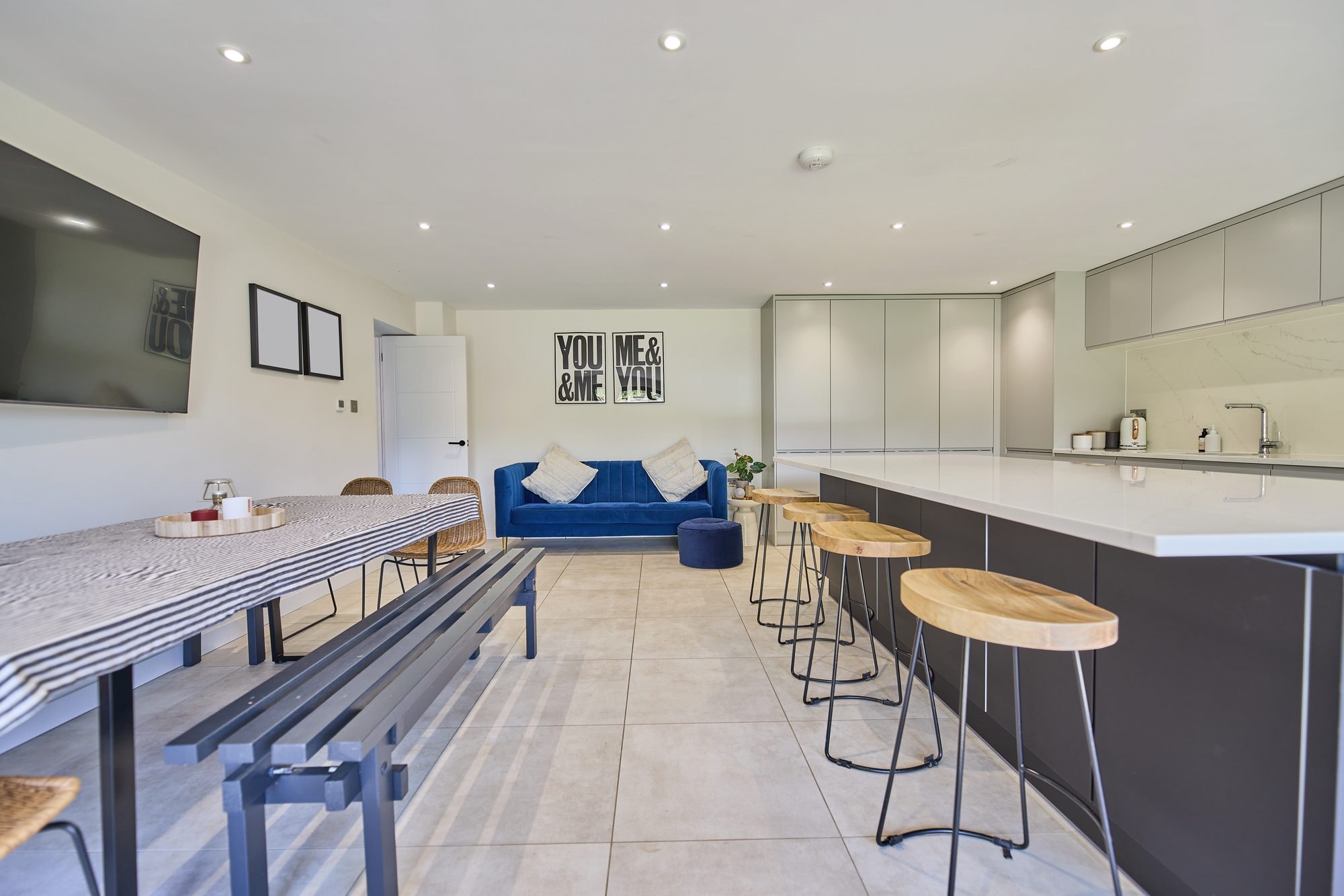 The finished open plan kitchen and dining room with a large island and bi-fold doors at the Stevenage home by DNR Build (4 of 6)