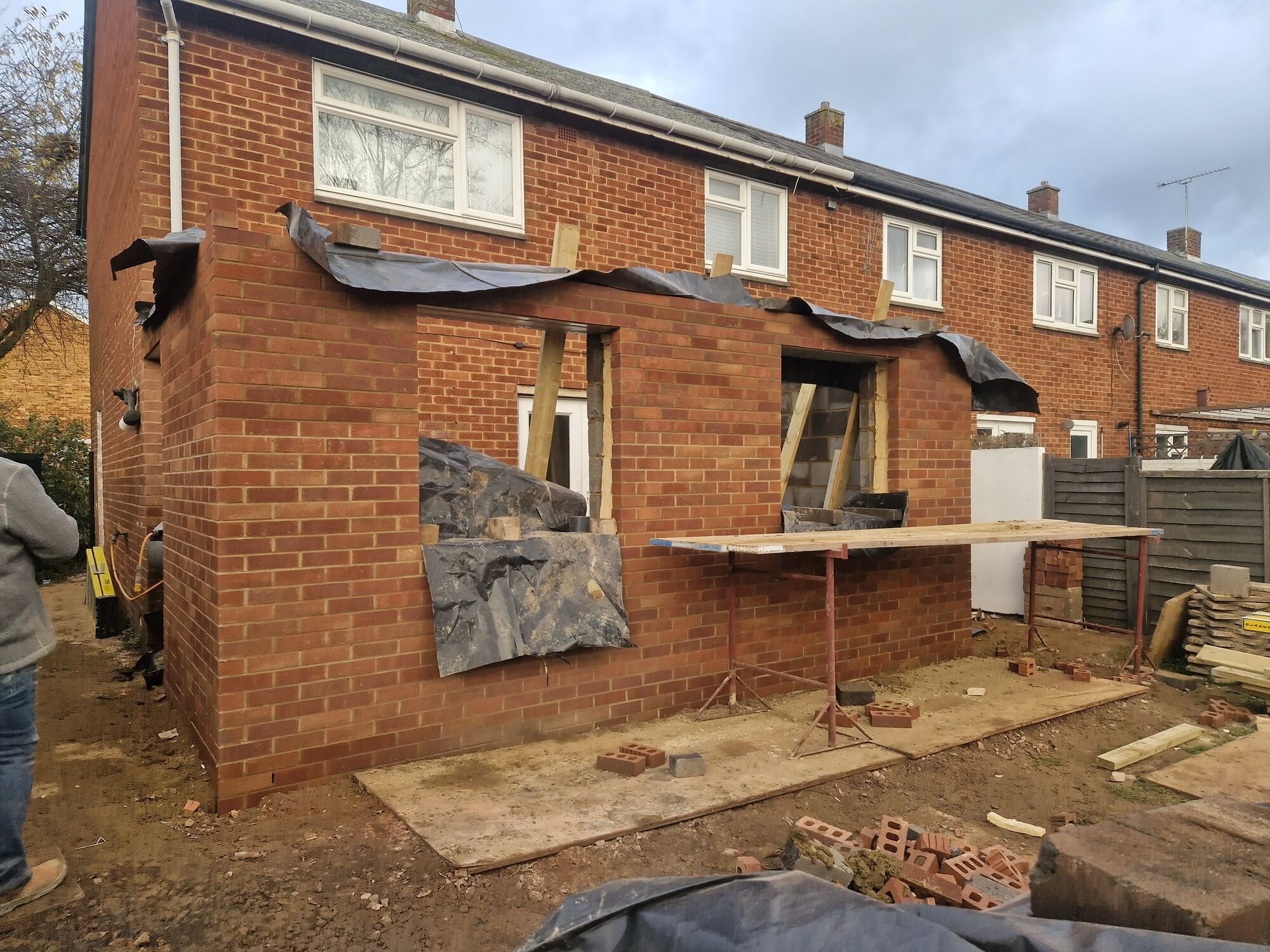 New extension walls going up in matched brickwork with openings formed for the windows and door by DNR Build