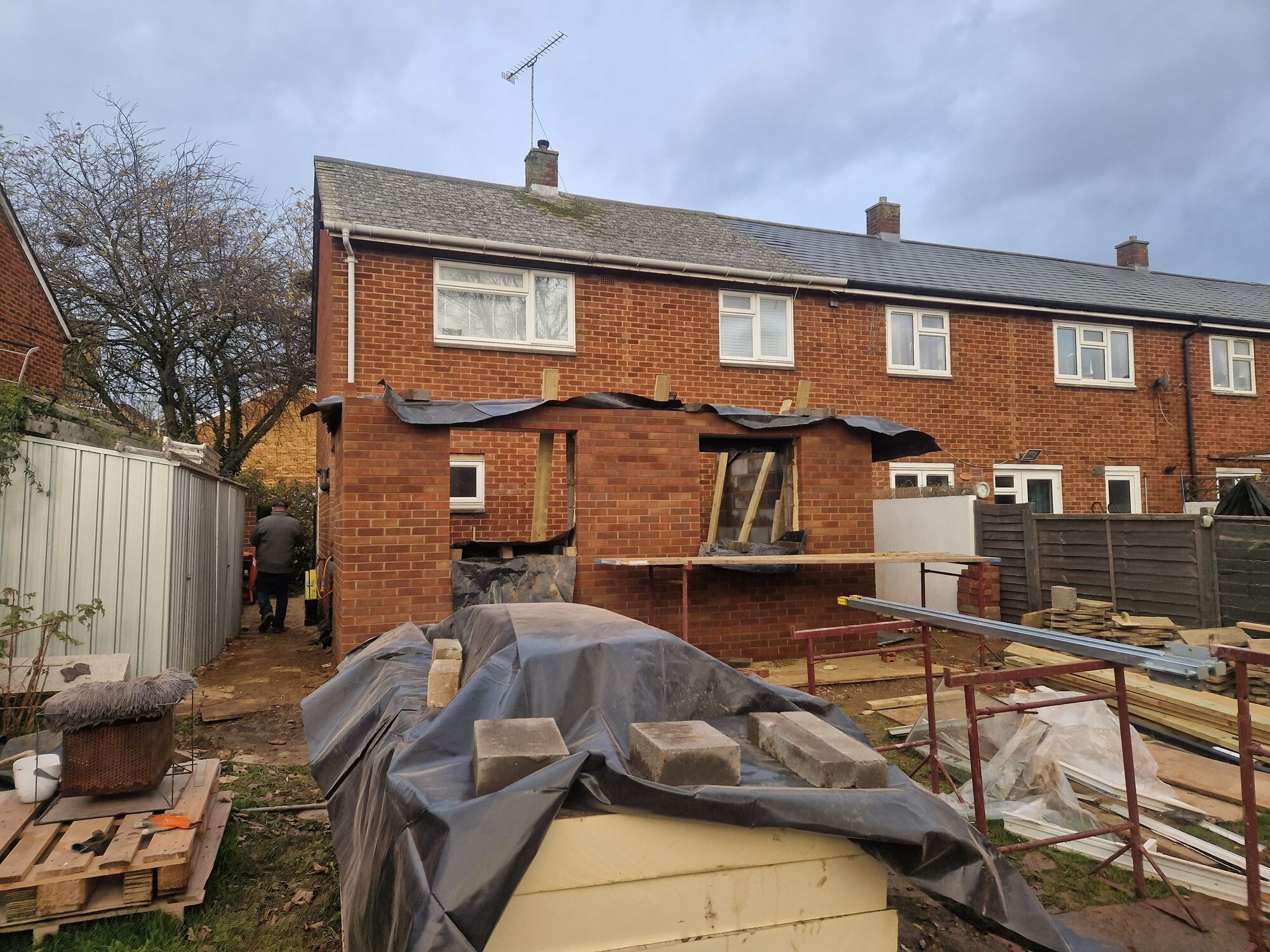 Wider view of the single storey rear extension under construction with scaffolding and materials on site by DNR Build