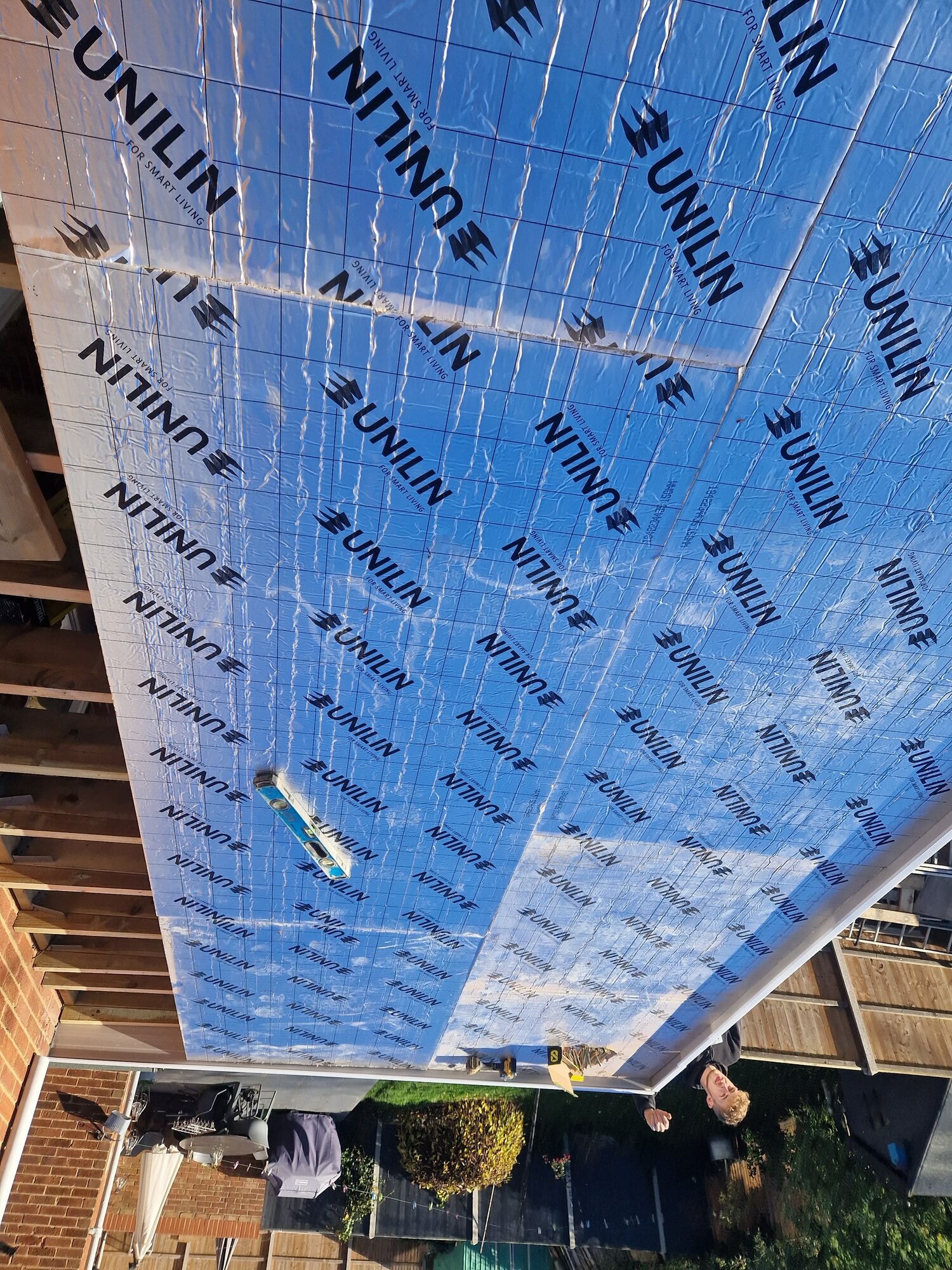 Insulated roof boards being laid over the new single storey extension by DNR Build