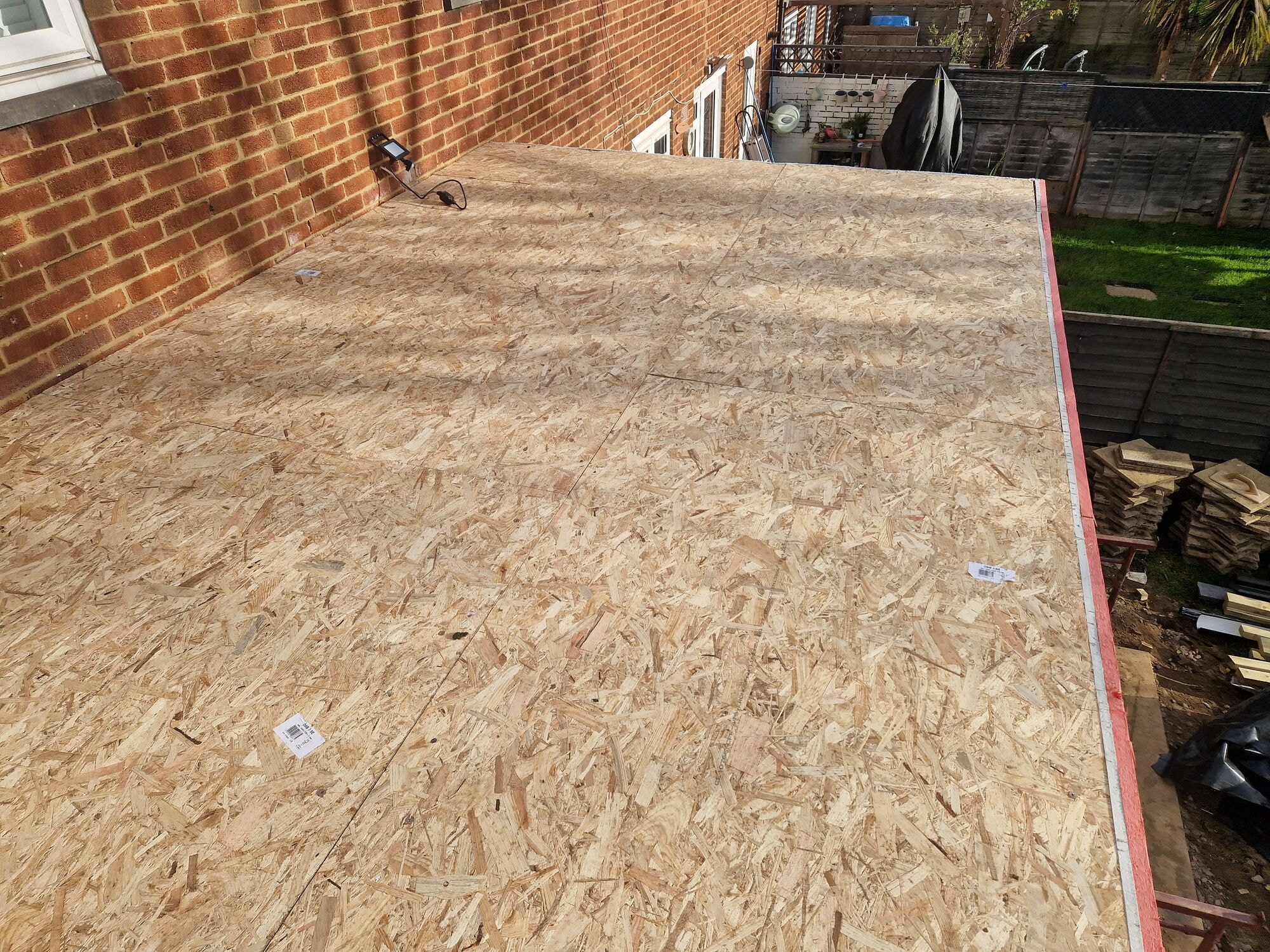 New OSB roof decking laid across the flat roof of the extension by DNR Build