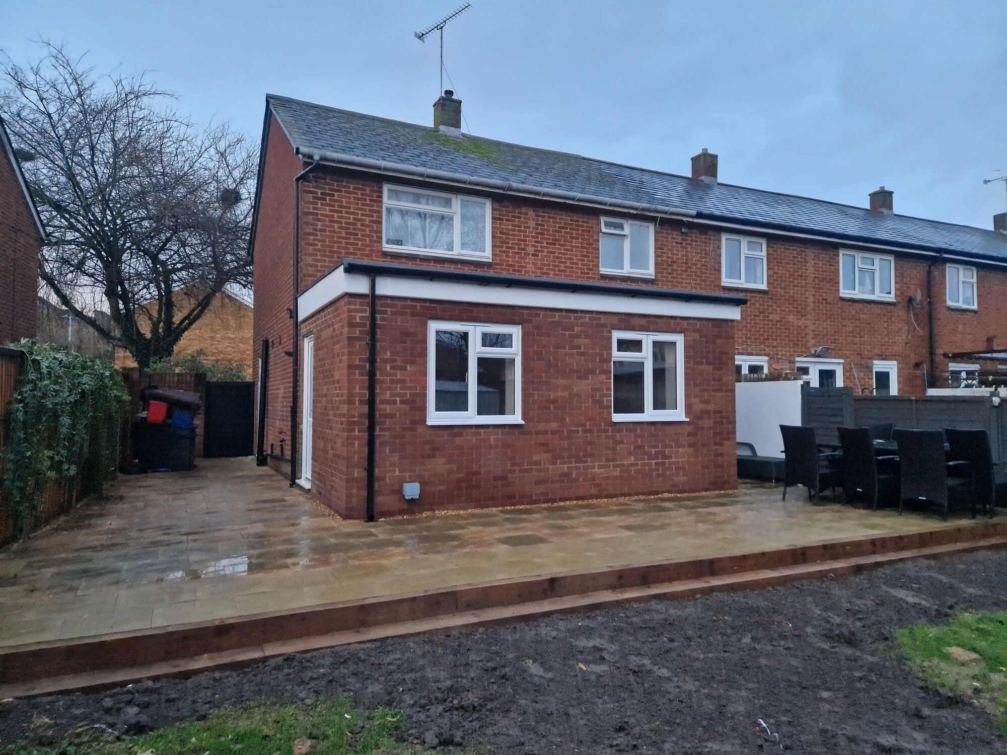 The completed single storey rear extension with new windows, door and patio by DNR Build
