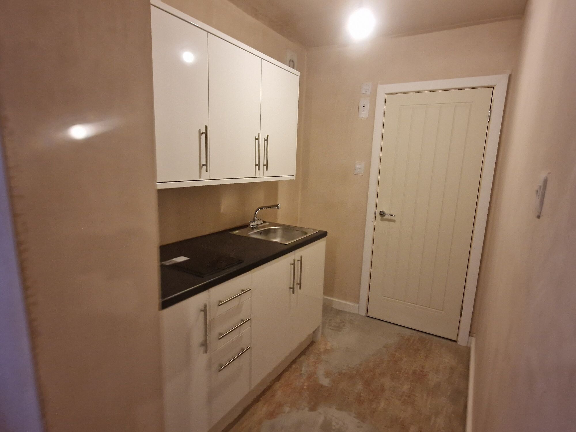 New fitted utility area with white gloss units and a sink in the extension by DNR Build