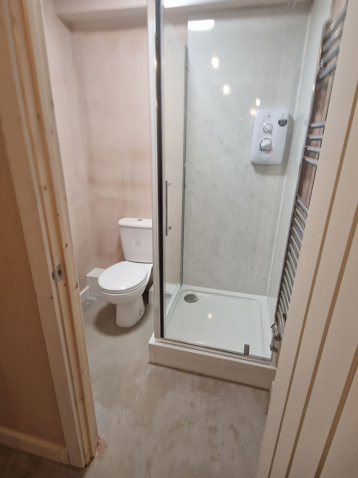 New shower room with a shower enclosure and WC during fit out by DNR Build