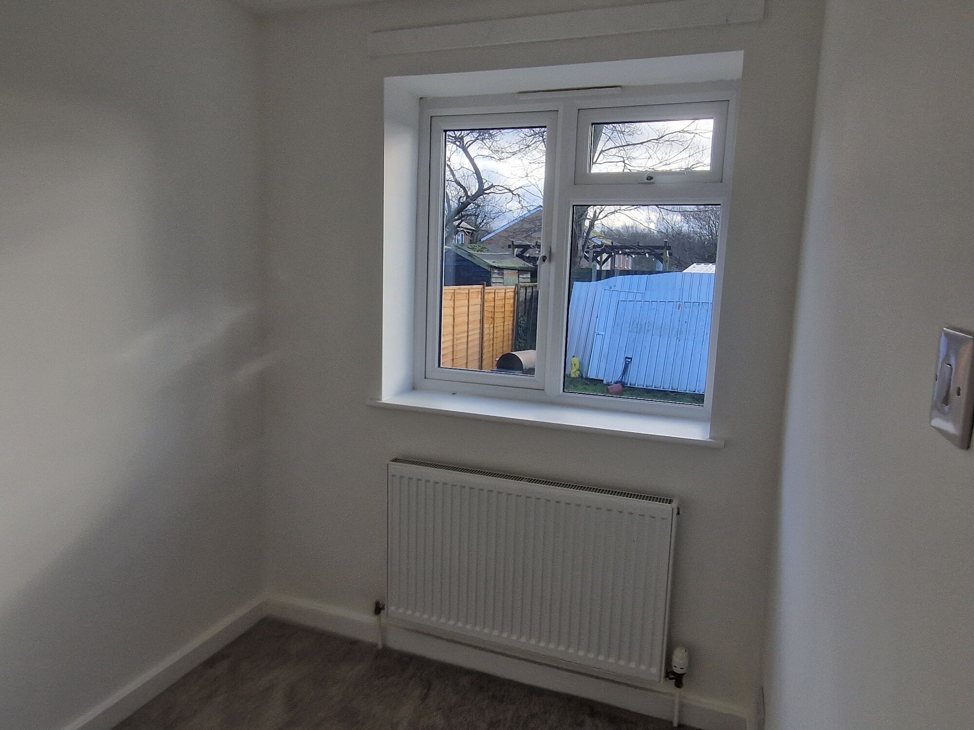 Finished and decorated bedroom with a new window and flooring in the extension by DNR Build