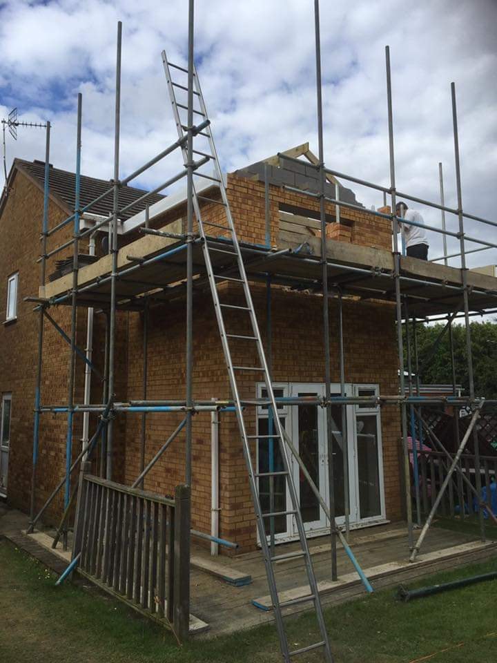 The new first floor walls being built in matched brickwork and blockwork on the scaffold by DNR Build
