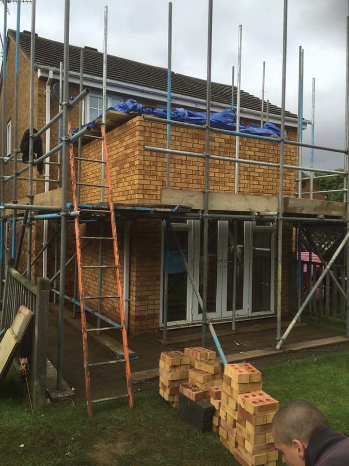 New first floor brickwork raised over the existing single storey extension by DNR Build