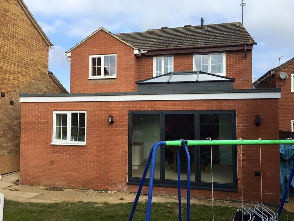 The finished single storey brick extension with bi-fold doors and the roof lantern on the flat roof by DNR Build