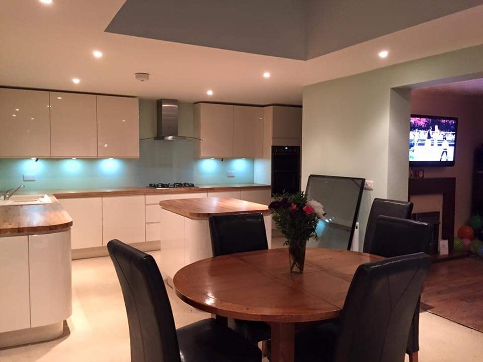 The finished open-plan kitchen and dining space with the new high gloss kitchen and island by DNR Build