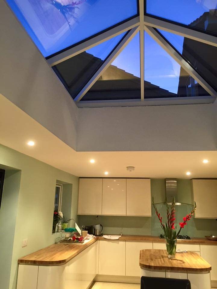 The glazed roof lantern over the finished kitchen drawing daylight into the open-plan space by DNR Build