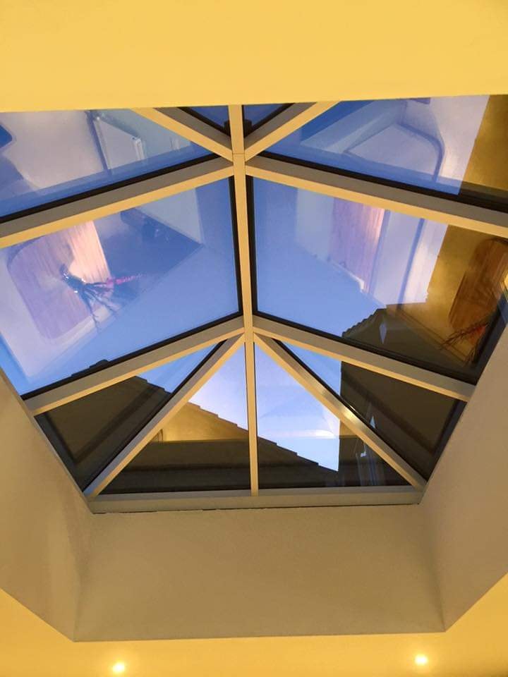 Looking up through the roof lantern to blue sky from the finished kitchen by DNR Build