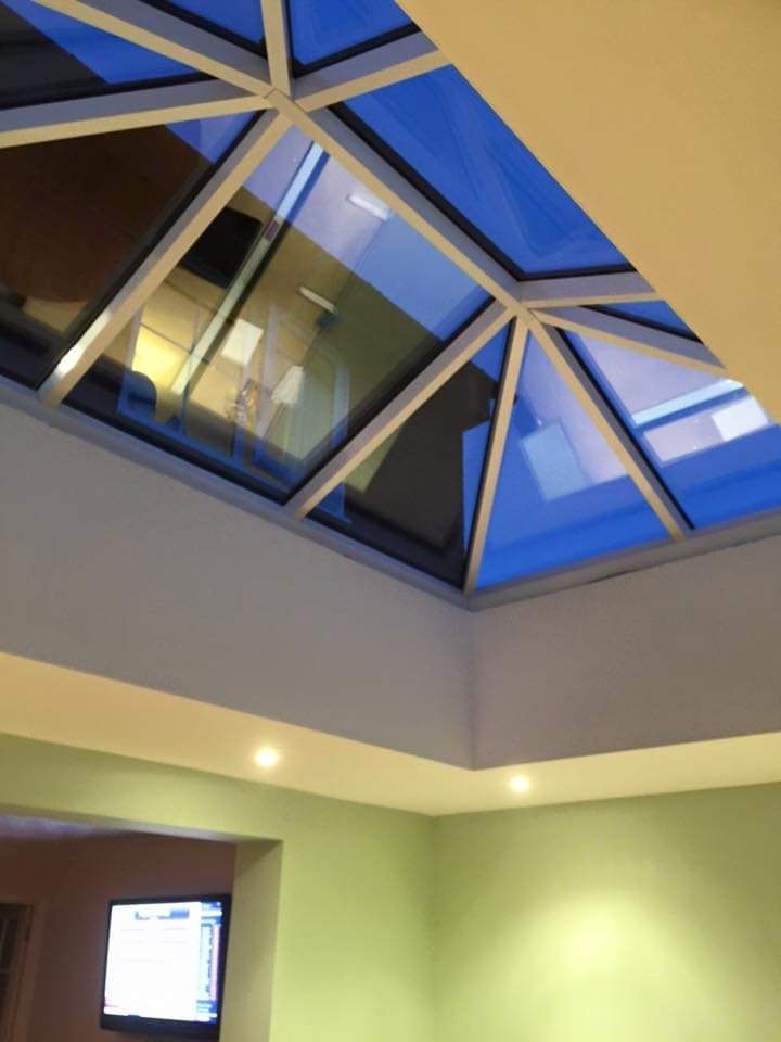 The roof lantern and tray ceiling over the open-plan kitchen and living space by DNR Build