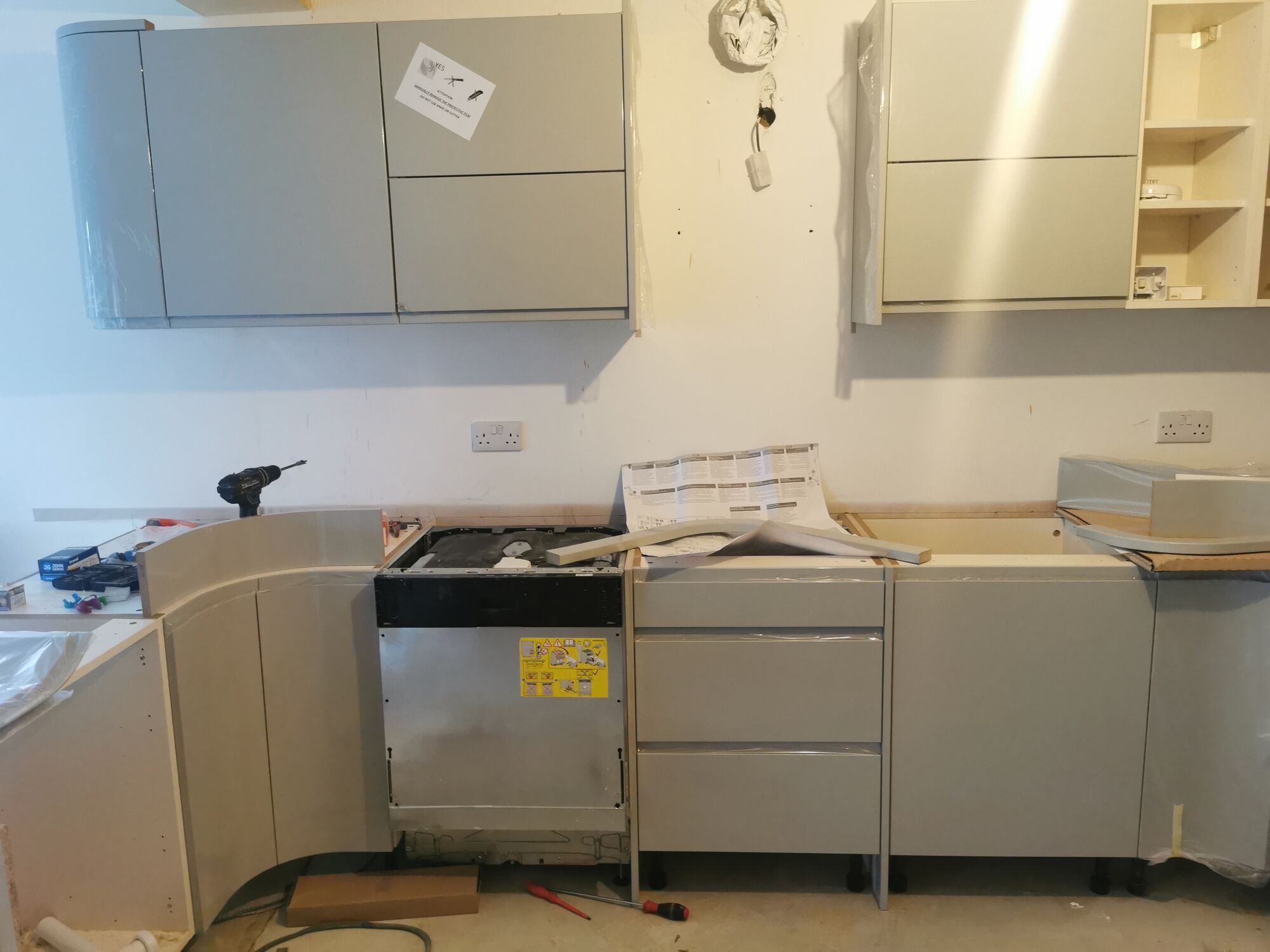The new high gloss kitchen units and integrated appliances being fitted by DNR Build